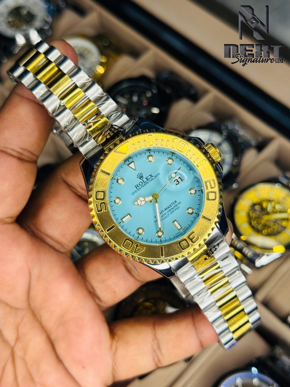 Rolex. Yacht-Master watch with a distinctive green dial and a two-tone gold and steel bracelet.